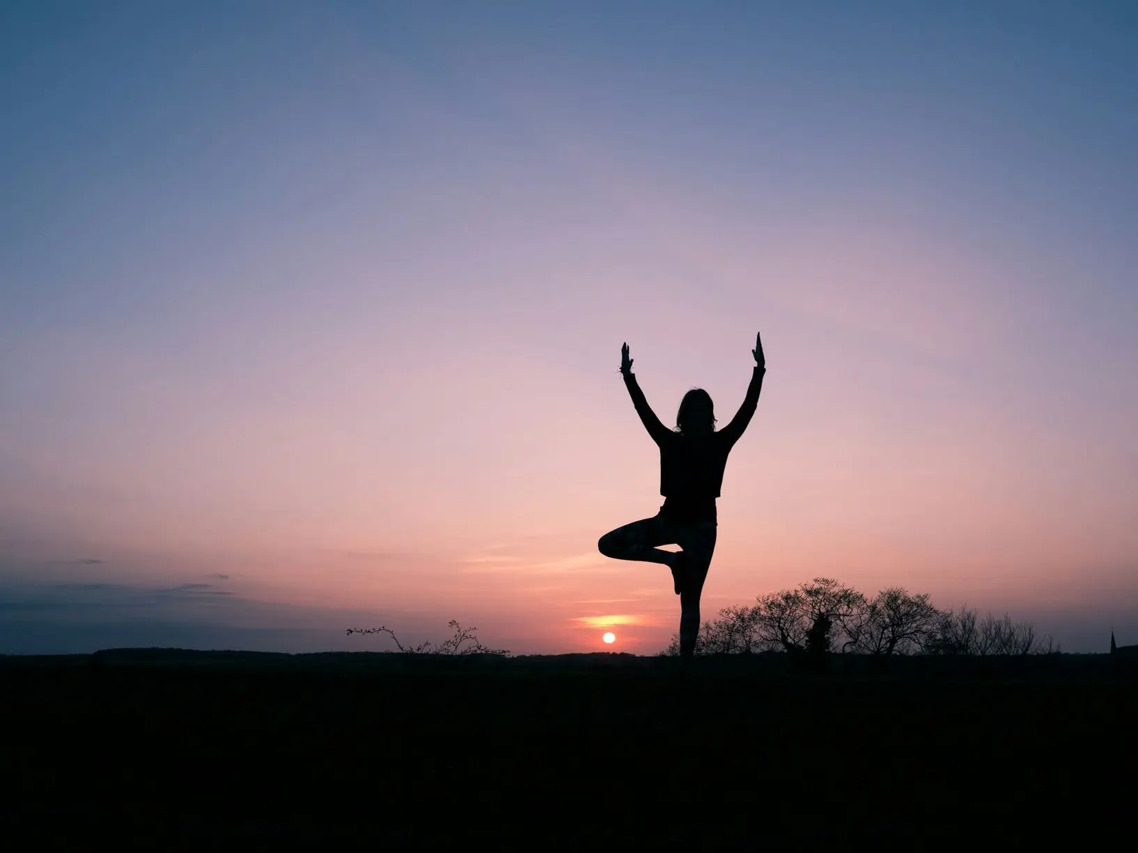 silhouette of person balancing using 1 foot